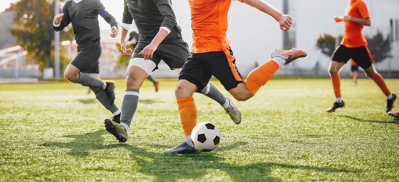 Footballers on pitch