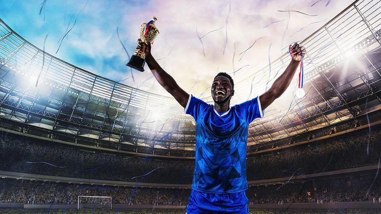 Footballer holding trophy