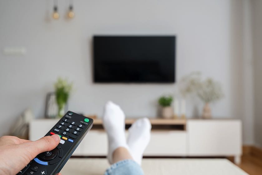Female holding remote with TV off