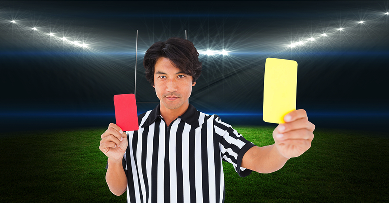 Ref holding yellow and red cards