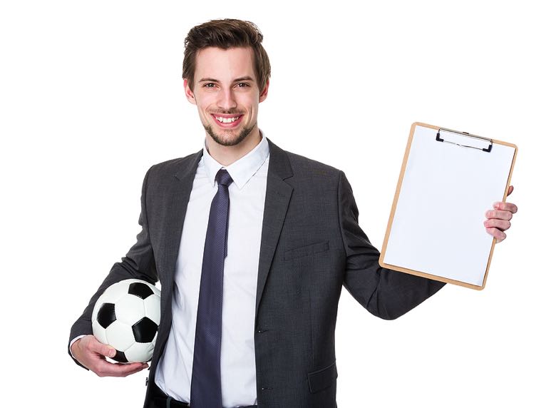 Man with clipboard holding football